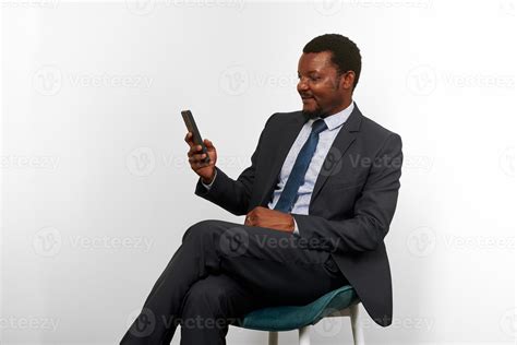 Smiling African American Black Man In Business Suit Sitting On Chair