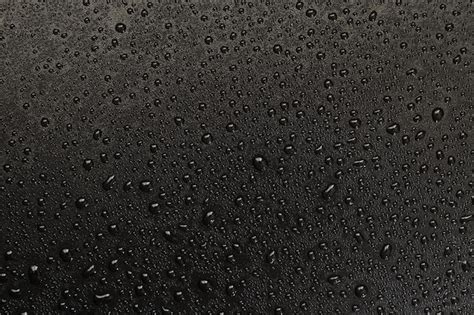 Premium Photo Drops Of Water On A Black Background Macro Photo