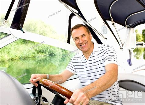 Man Driving Boat On River Stock Photo Picture And Royalty Free Image