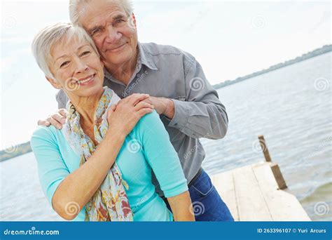 Timeless Love A Mature Husband And Wife Looking At The Camera And Smiling While Standing On A