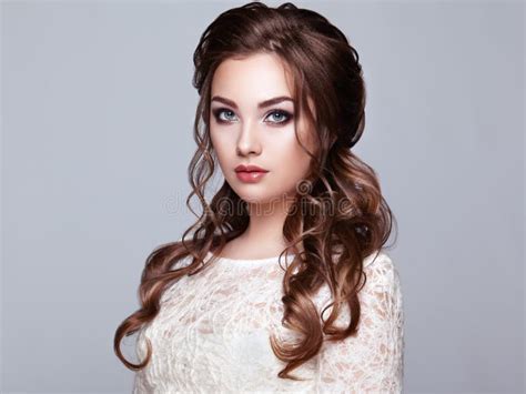 Brunette Woman With Curly Hairstyle Laying On A Floor Near Luxury Bed