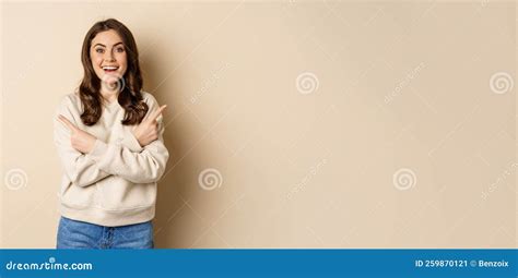 Happy Smiling Girl Brunette Pointing Sideways Showing Two Promo Offers
