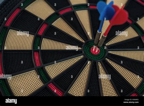 Two Darts On A Dartboard S Center Stock Photo Alamy