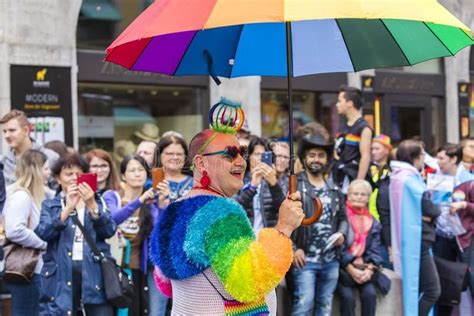 A Gay Man In An Exquisite Rainbow Costume Attending The Gay Pride Parade A SPONSORED