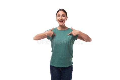 A Year Old Positive European Brunette Woman With A Ponytail Is Dressed In A Green T Shirt And