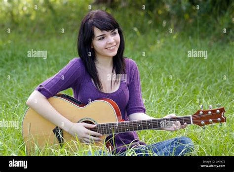 Beautiful Brunette Outdoors With A Guitar 1 Stock Photo Alamy