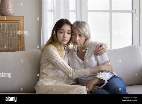 Sad Teen Granddaughter Hugging Depressed Mature Grandmother Stock Photo Alamy
