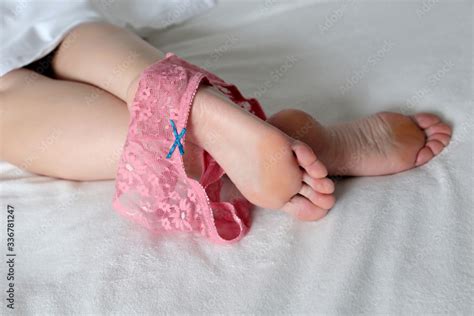 Female Legs With Removed Pink Panties On A Bed Sex Concept Naked Woman Lying On Her Belly