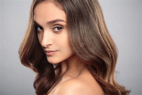 Brunette Girl With Healthy Curly Hair And Natural Make Up Beautiful Model Woman With Wavy