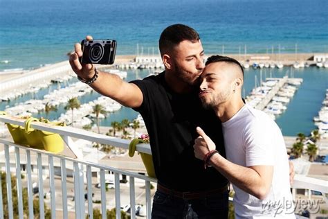 Una Pareja Gay Se Hace Un Selfie En El Balc N Con El Puerto Detr S Wall Mural Murals Friends