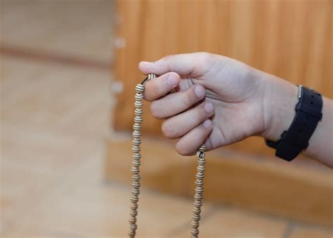 Premium Photo Beautiful Boy Hands Praying With The Rosary A Hand