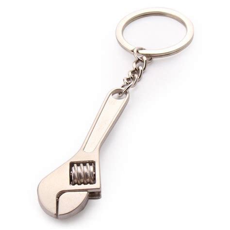 A Wrench Shaped Keychain Is Shown On A White Background