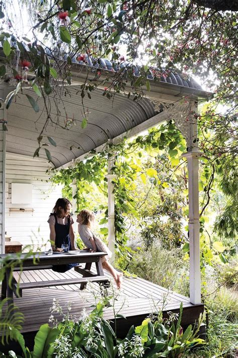 An Art Filled Historic Queenslander Framed By Neat Green Hedges And