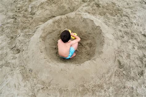 270+ Kids Digging Holes In The Sand Stock Photos, Pictures & Royalty ...