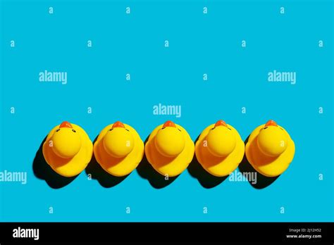 Yellow Rubber Ducks Arranged In A Row On Blue Background Business Team