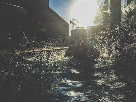 Premium Photo | People splashing water in swimming pool