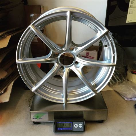 a silver wheel sitting on top of a scale