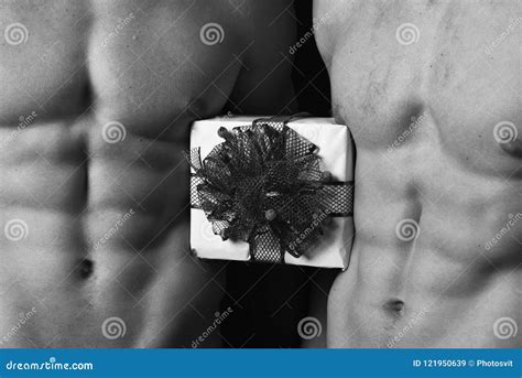 Athletes In Close Up Holding White Gift Box With Red Bow For Christmas Male Twins With Naked