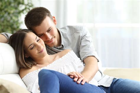 Couple Cuddling Sitting On The Sand Of The Beach Stock Image Image Of