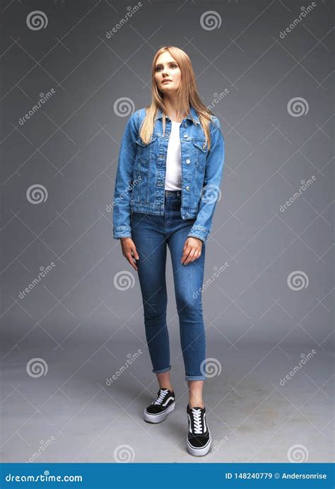 Beautiful Blonde Woman Dressed In A Denim Jacket And Blue Jeans Stock Image Image Of Blue