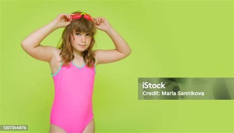 A Beautiful Preteen Girl In A Pink Colorful Bathing Suit Getting Ready