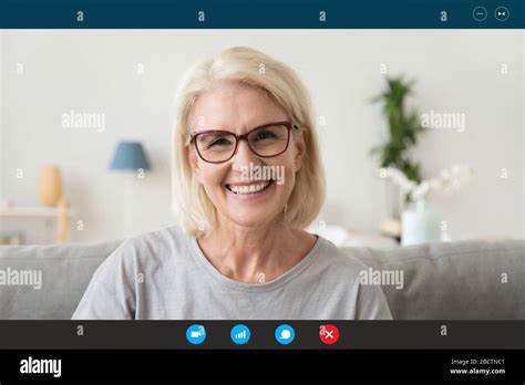 Mature Woman Looking At Webcam Chatting With Relatives By Videoconference Stock Photo Alamy
