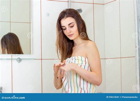 Junger Zarter Brunette Im Tuch Steht Im Badezimmer Und Im Setzen Der Handcreme Stockbild Bild