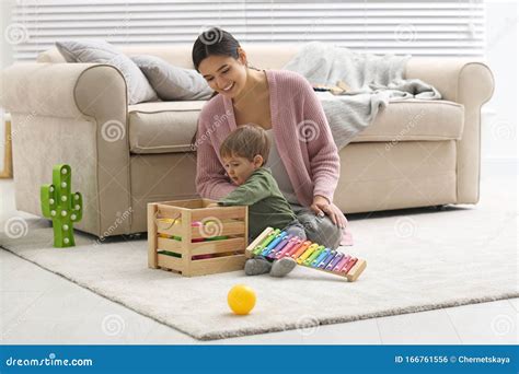 Young Nanny And Cute Little Baby Playing With Toys Stock Photo Image
