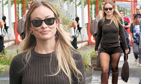 Olivia Wilde Pairs Tiny HOT PANTS With Sheer Stockings And Go Go Boots During Michael Kors
