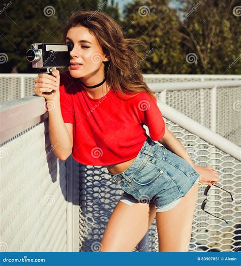 Het Jonge Blonde Gelukkige Glimlachen Verraste Meisje In Rode Bovenkant Borrels Zonnebril En