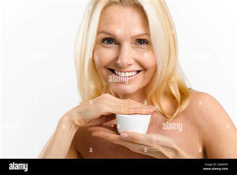 Skincare Routine Charming Middle Aged Blonde 40s Woman Holding Jar With Anti Aging Moisturizer