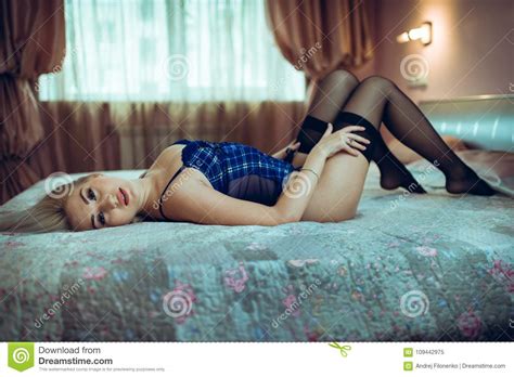 Blonde In Lingerie And Black Stockings Lies On The Bed Stock Image Image Of Indoors Blue