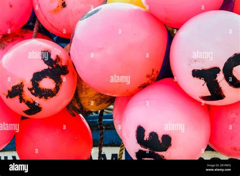 A Collection Of Red Plastic Buoyancy Floats On A Boat Dorset Uk Stock