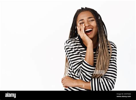 Portrait Of African American Woman Laughing And Smiling Touching Her