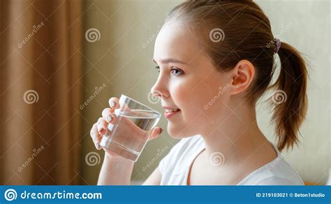 Smile Young Woman Drinks Glass Of Pure Water In Morning After Waking Up