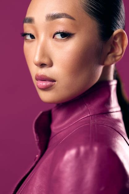 Premium Photo Fashionable Asian Brunette Woman In A Purple Leather Jacket With Her Hair Tied