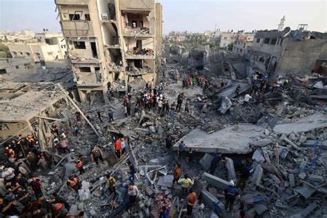 ‘The whole building fell on us’: Blast at refugee camp in central Gaza kills dozens