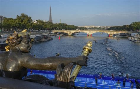 ‘What a special place to be in.’ Triathletes swim in the Seine ahead of Paris Olympics