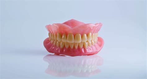  If the lower teeth are visible but comfortable and functional, then there is no issue