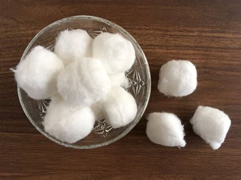  Use damp cotton balls with warm water or a small dab of petroleum jelly on your finger