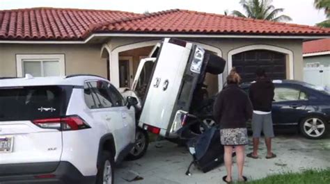 1 airlifted after pickup truck ends up wedged between 2 cars outside NW Miami-Dade home
