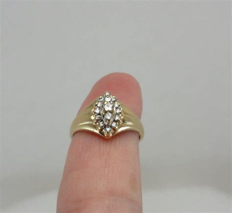 T his is a beautiful vintage yellow Gold with Diamonds Ring. Stamped 14KP ( karat plumb" gold---meaning exactly 14K ) & SMG Size 6 1/2 12 high grade diamonds Weighs 6 grams Purchased in the 1970s Insured for $320 Swirling elegant shape, symmetrical from every angle Excellent condition with little sign of wear.. 