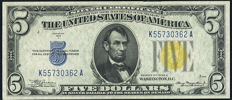 All 1934 $5 bills feature the Lincoln Memorial on the back page regardless of the seal stamped on the front page. The denomination FIVE DOLLARS is below the building, while the name UNITED STATES OF AMERICA is along the upper edge. Only bills with a brown seal have overprinted HAWAII across the entire page. Other features of the 1934 $5 bill. 