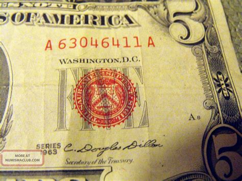 This 1963 $5 dollar bill features a distinctive red seal and star note. It is an uncirculated replacement note from the United States, without any certification or grading. The denomination, year, and country of manufacture are clearly indicated. ... This 1963 $5 dollar bill features a distinctive red seal and star note. It is an uncirculated .... 