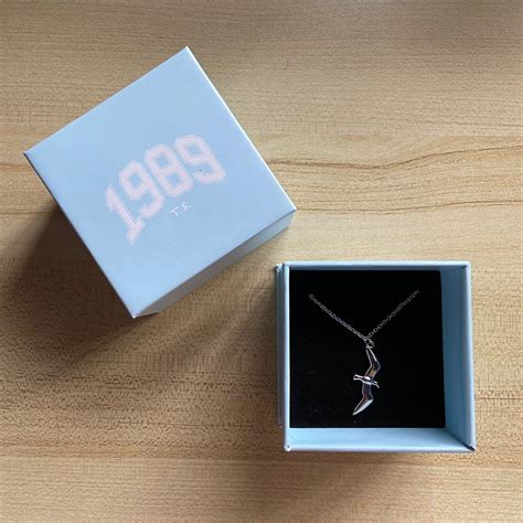 Taylor Swift 1989 Seagull Mini Silver Necklace DUPE $15. Taylor Swift Speak Now Eras Tour necklace Swiftie gift $16. Taylor Swift Merch Gold Chain Folklore Album Necklace Jewelry The Eras Tour NEW $24 $29 Taylor Swift 1989 Seagull Necklace with Box $60 $1,989 Eras Tour .... 