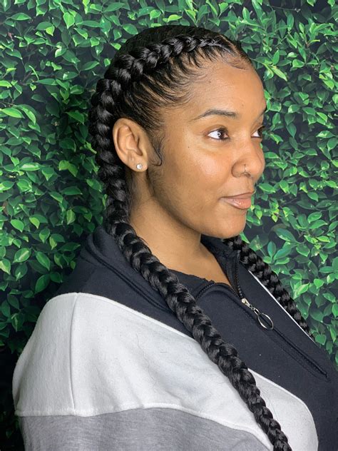 2 feed in braids with designs in the middle. 6. Middle-Part Cornrows Medium-length cornrows are great for everyday wear. Photo from @yaakankam. With cornrow hairstyles, there is no one size fits. From all-over braids to this center-parted option, a style is certainly designed for every preference! This looks excellent for naturalistas who love their middle parts regardless of the hairstyle! 