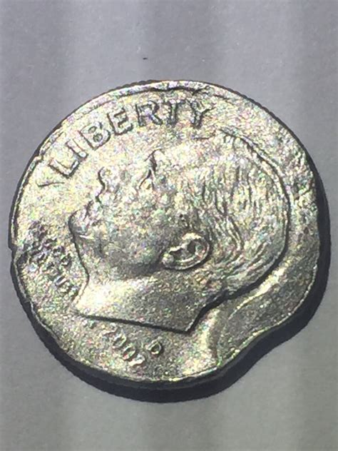 The 2002-P Roosevelt Dime was made by the United States Mint. This coin is made out of a clad material, meaning that the outer layer is a mixture of copper and nickel, while the inside core is solid copper. These coins, baring a special circumstance, will be worth face value. On the obverse of the coin is text that reads "Liberty, In God We ...