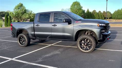 Not sure what a z60 is but I have a 2013 z71 4x4 with oem 20's.. Tire is a 275/60-20 which is 33". Wider offset wheels may give you problems. I am running a 2" rough country level. Not even close to rubbing any where no matter turning or hitting bumps while turning even in reverse..