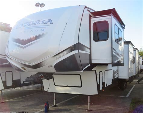 Each one of these Dutchmen RV Astoria fifth wheels and travel trailers offer highly visible, value-driven standard features and a sturdy construction with a fiberglass exterior! Dark-tinted safety glass windows offer privacy and a sleek design. You can store your outdoor gear in the pass-through storage areas and the slam latch baggage doors on ... . 