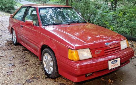 1988 red ford escort gt sticeblack tail piece pictures  Base price on the '87 Escort wagon was $7,312, or